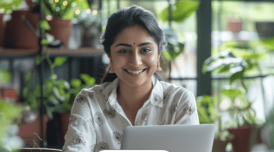 Woman smiling while working on a laptop